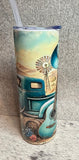 Tumbler with a design of a blue truck, guitar, and windmill against a desert landscape.