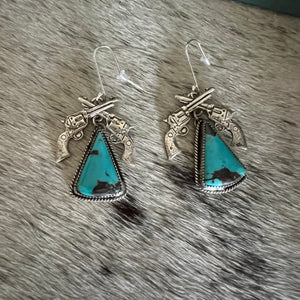 Crossed pistols and turquoise earring